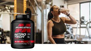 a lady drinking muscletech protein drink